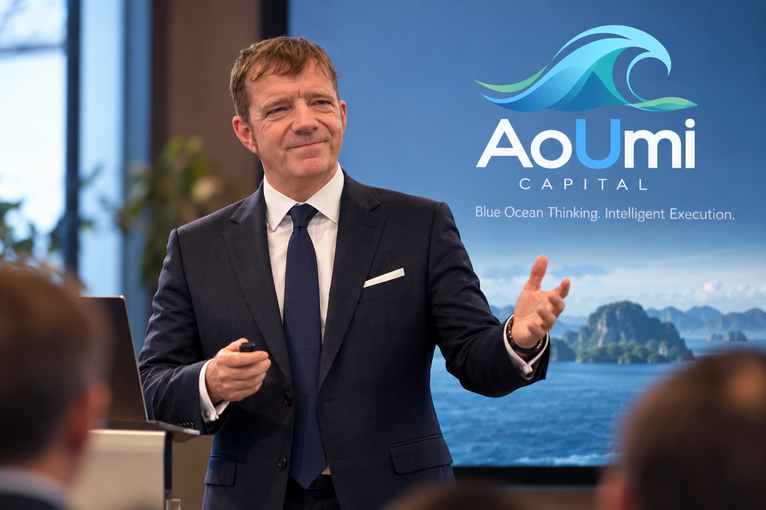 Andy Rutherford in front of an AoUmi Capital backdrop